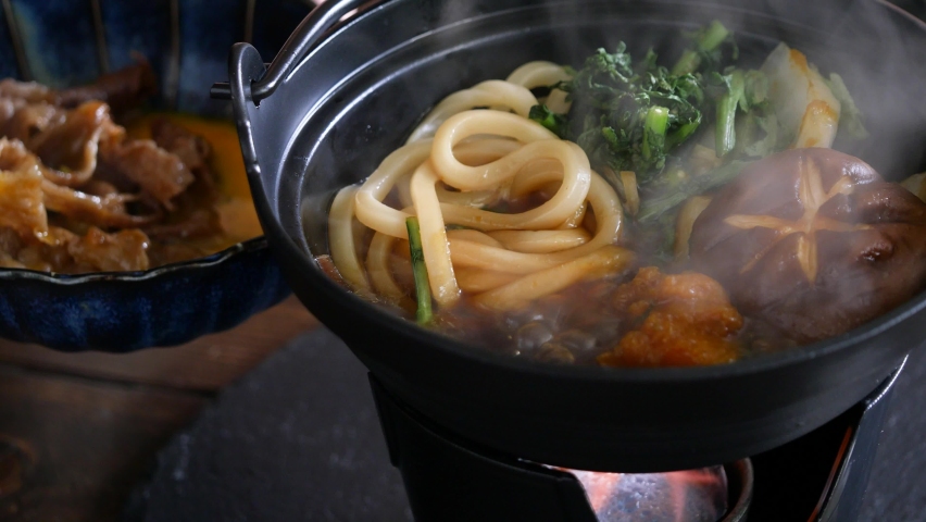 Sukiyaki. A video of eating udon with raw eggs. | Shutterstock HD Video #1083071428