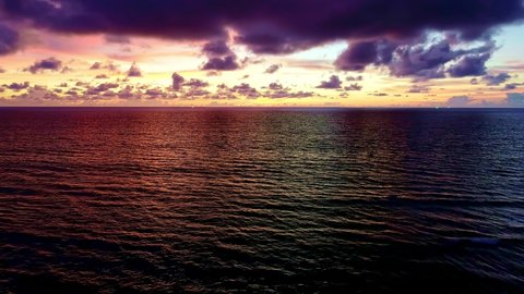Tropical sea at sunset or sunrise over sea video 4K, The sun touches horizon, Dramatic sky in golden hour amazing seascape,Ocean beach sunsets Crashing wave on sandy shore Fantastic natural sunsets