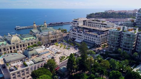 View of the old casino. area with palm trees. Luxurious super cars in front of the hotel Masked tourists. Monument and fountain. Modern architecture of the kingdom of MONTE CARLO MONACO NOVEMBER 2021