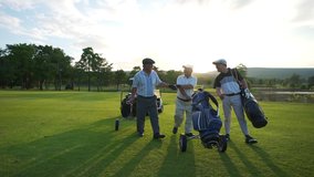 4K Group of Asian people businessman and senior CEO enjoy outdoor sport  golfing together at country club. Healthy men golfer holding golf bag walking on fairway with talking together at summer sunset - Powered by Shutterstock - Get 15% off with code: PIKWIZARD15