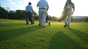 4K Group of Asian people businessman and senior CEO enjoy outdoor sport  golfing together at country club. Healthy men golfer holding golf bag walking on fairway with talking together at summer sunset - Powered by Shutterstock - Get 15% off with code: PIKWIZARD15