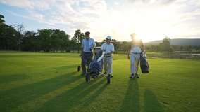 4K Group of Asian people businessman and senior CEO enjoy outdoor sport  golfing together at country club. Healthy men golfer holding golf bag walking on fairway with talking together at summer sunset - Powered by Shutterstock - Get 15% off with code: PIKWIZARD15