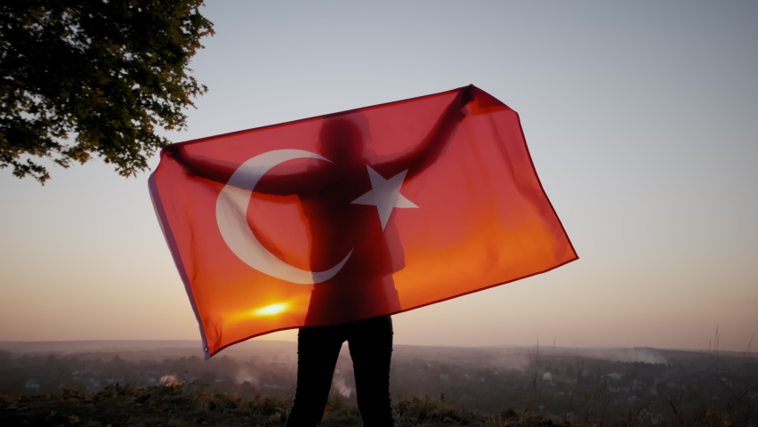 Back view of happy woman with turkish national flag standing outdoors at sunset. slow motion sgot | Shutterstock HD Video #1083091657