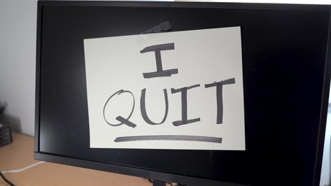 Note on a monitor of a work computer with the text I QUIT. Great resignation concept