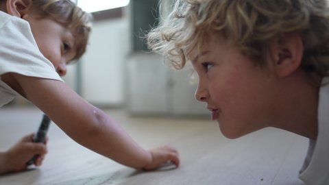 Young brother not wanting to share toy with toddler sibling