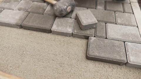 Worker puts a tile on the groung