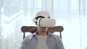 Slow motion footage of Hispanic man wearing virtual reality headset watching inside cyberspace. he is watching movies and surfing the net. - Powered by Shutterstock - Get 15% off with code: PIKWIZARD15