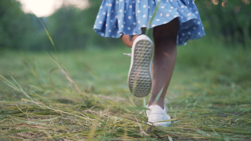 Little girl run on grass in park. Active child. Girl feet on grass. Child runs in the park. Girl play in forest park. Happy child run in forest. Child play active games. Happy girl running on grass | Shutterstock HD Video #1083103765