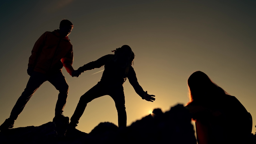 Family team success.Silhouette of group people.Climb to the top of mountain.Helping hand family victory.Teamwork concept.Business handshake.Helping hand of business people.Teamwork is path to success Royalty-Free Stock Footage #1083103774