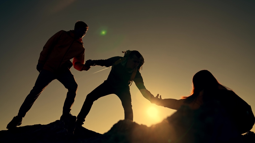 Family team success.Silhouette of group people.Climb to the top of mountain.Helping hand family victory.Teamwork concept.Business handshake.Helping hand of business people.Teamwork is path to success | Shutterstock HD Video #1083103774