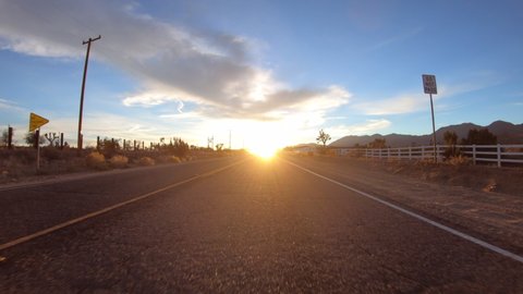 Driving into sunrise on Ft Tejon Road in the Mojave desert near Littlerock and Pearblossom California.