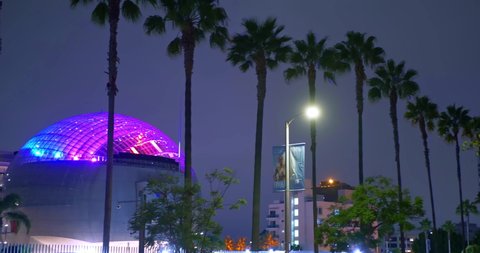LOS ANGELES, CALIFORNIA, USA - SEPTEMBER 27, 2021: Panorama of the Academy Museum of Motion Pictures at night on Wilshire Boulevard (Miracle Mile) in Los Angeles, California, 4K