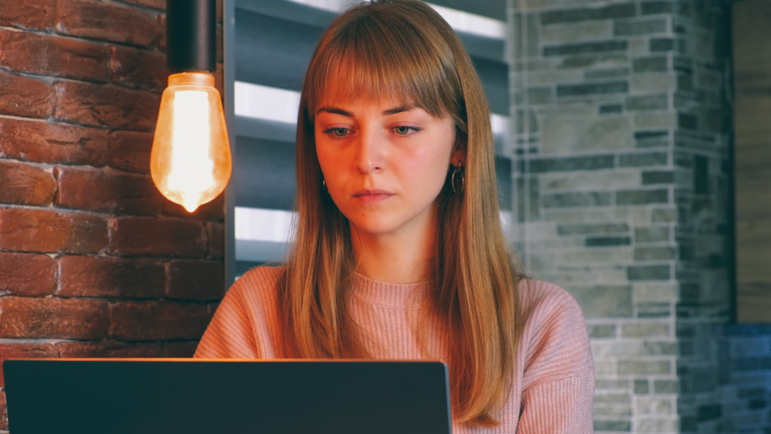 Pensive worried Caucasian woman working on laptop computer looking to the side thinking about problem solution at home office, serious woman looking for inspiration makes a decision, close-up view Royalty-Free Stock Footage #1083114232