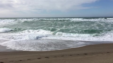 Handheld Low View Of Northern California Waves On Beach Cloudy Sky
