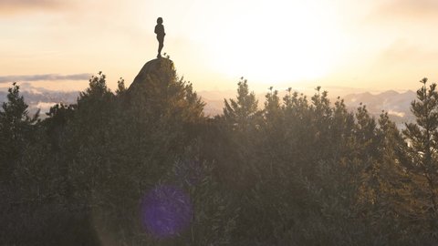 Adventurous Caucasian Adult Woman Standing on top of a Rocky Mountain. Sunset Sky Art. 3d Rendering peak. Aerial Background Image from British Columbia, Canada. Adventure Concept