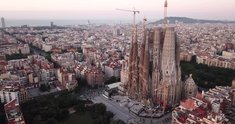BARCELONA, SPAIN- JUNE 13, 2019: Aerial view of Sagrada Familia on background of Eixample district cityscape 