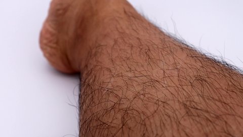 Japanese man pulling unwanted hair on his legs