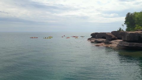 Aerial view of a group of kayakers exploring at Lake Superior during summer time, travel and enjoy the outdoor