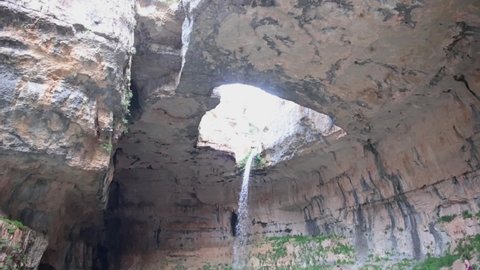 High waterfall drop in Balue Balaa sinkhole location, camera tilt down view