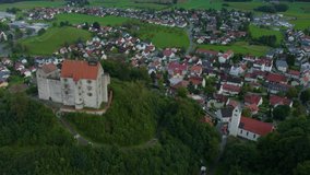 Aerial around the village Waldburg in Germany on a cloudy afternoon in summer	