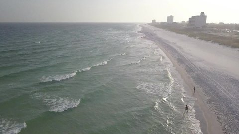 People Walking Along The Pensacola Beach In Florida, United States. aerial, forward