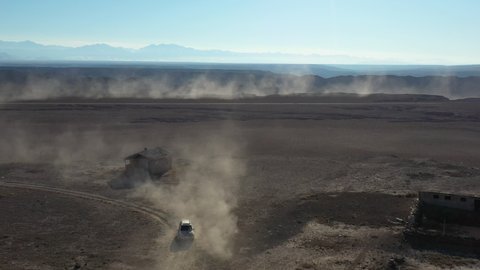 Cinematic tracking and revealing drone shot of cars traveling along the Charyn Canyon, Kazakhstan