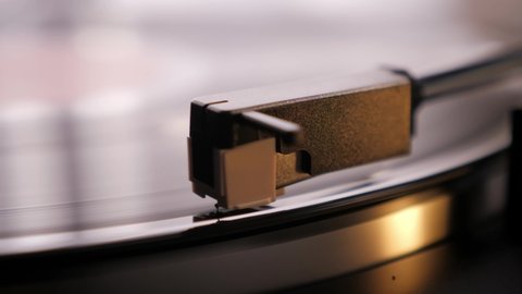 Turning off vinyl record, close up. Spinning vinyl record and needle. Vintage record turntable