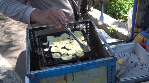 A seller makes Cilor. A typical West Java food made from cooked starch wrapped in egg.
