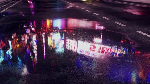 Rain Drops in the City Streets Puddles - Loop Motion Graphic Background