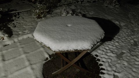 snow-covered table at night in winter