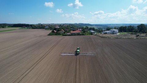 The tractor sprays the field with pesticides and agrochemicals. Extermination of pests and diseases. Top view.