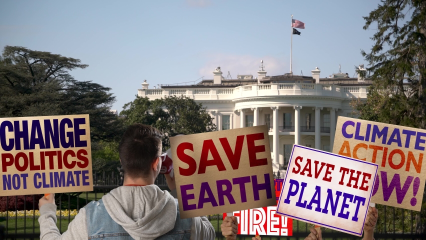 Climate Change activist protestors with signs and megaphone outside the White House, presidents residence in Washington, DC.