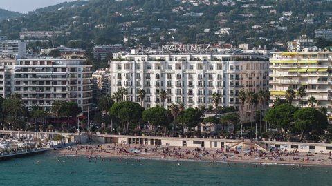 Establishing Aerial View Shot of Cannes French Riviera Fr, French Riviera, Alpes-Maritimes, France, holidaymakers relaxing in the sun
