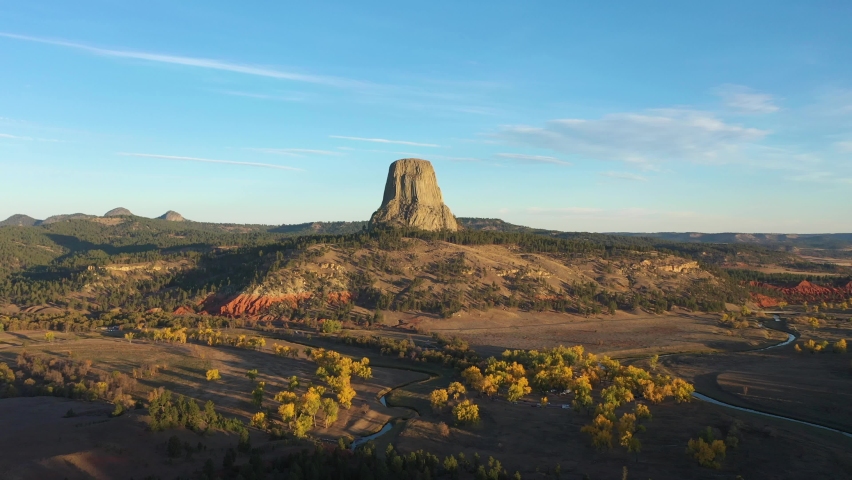 Devils Tower Butte and Belle Fourche River in Sunny Autumn Morning. Crook County. Wyoming, USA. Aerial View. Drone is Orbiting