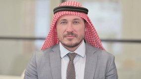 Portrait of Middle Aged Arab Businessman Talking on Online Video Call