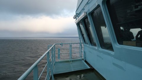 Close-up of the wheelhouse. The captain's bridge. Reflections of the sea are visible in the windows of the bridge.