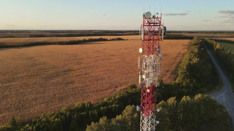 Cell site of telephone tower with 5G base station transceiver. Aerial view of telecommunication antenna mast