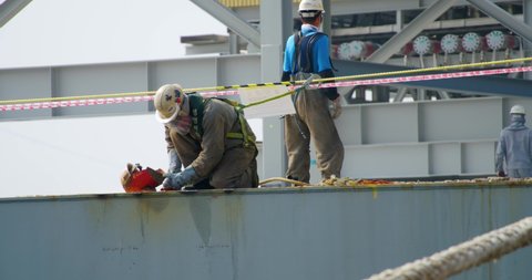 Okpo-dong, South Korea - May 30, 2016: Shipyard workers work on the deck of a ship being repaired.