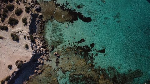 Aerial drone view of the rocky coast and the Mediterranean Sea near the scenic Aphrodite Trail in the Akamas Peninsula National Park, Cyprus. Famous tourist travel destination near Polis city, Cyprus