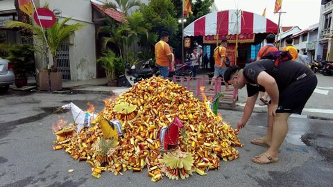 Georgetown , Penang , Malaysia - 10 20 2021: Chinese devotee burn the joss paper during worship