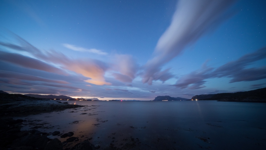 Northern lights above the Alta fjord. Tide goes in and out. Full night timelapse.
