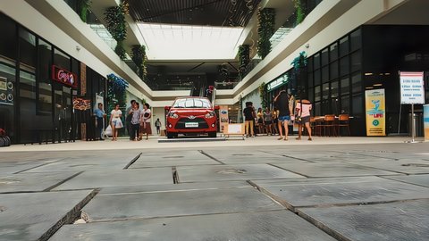 leyte , Philippines - 11 26 2021: timelapse of mall lifestyle hours with car raffle prize in the center as an attraction for tourists and customers with restaurants