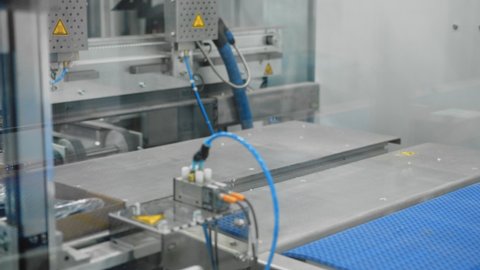 Goods being boxed in automated packaging system; innovative engineering
