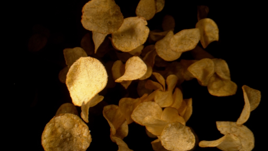 Super Slow Motion Shot of Potato Chips Flying Towards the Camera at 1000fps. | Shutterstock HD Video #1083184228