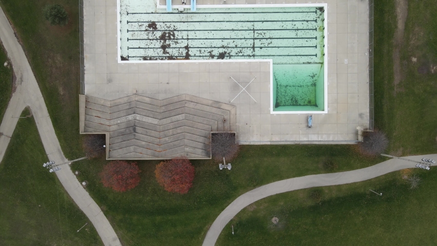 Anderson Park, Kenosha, Wisconsin, drone view of entire complex. Autumn leaves and trees shown.  Fence around perimeter.  Pond seen in corner. Trails for hiking and biking. 