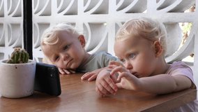 Small kids watching cartoons on the phone
