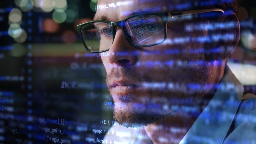 Portrait of Startup Digital Entrepreneur Working on Computer, Line of Code Projected on His Face and Reflecting in Glasses. Developer Working on Innovative e-Commerce App using AI and Big Data Royalty-Free Stock Footage #1083195043