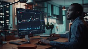 Home Office Evening: Black Financial Analyst Using Computer with Display Showing Real-Time Stocks, Exchange Market Charts. Remote Working African American Trader making e-Commerce Investment - Powered by Shutterstock - Get 15% off with code: PIKWIZARD15
