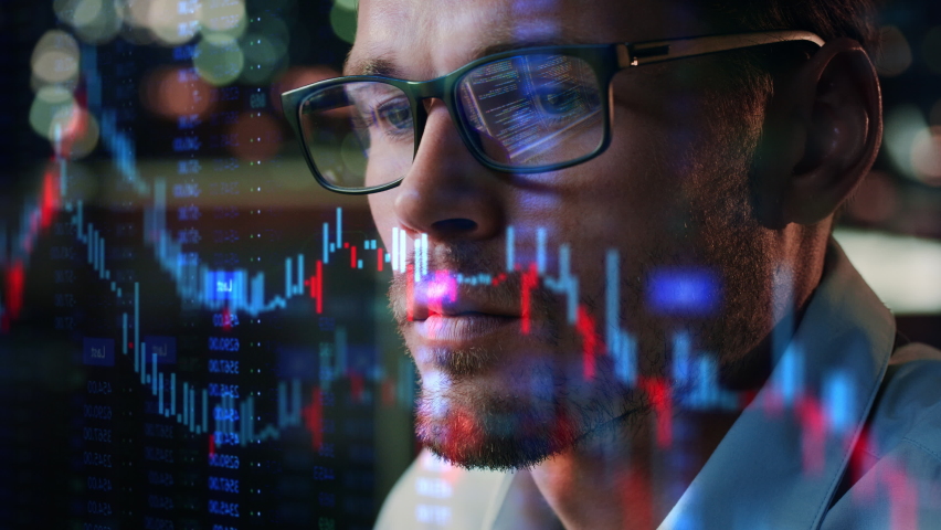 Stock Market Trader Working Investment Charts, Graphs, Ticker, Diagrams Projected on His Face and Reflecting in Glasses. Financial Analyst and Digital Businessman Selling Shorts and Buying Longs Royalty-Free Stock Footage #1083199012