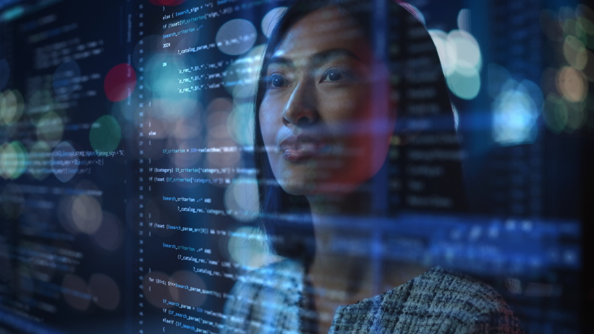 Portrait of Asian Female Startup Digital Entrepreneur Working on Computer, Line of Code Projected on His Face and Reflecting. Software Developer Working on Innovative e-Commerce App using AI, Big Data | Shutterstock HD Video #1083199081